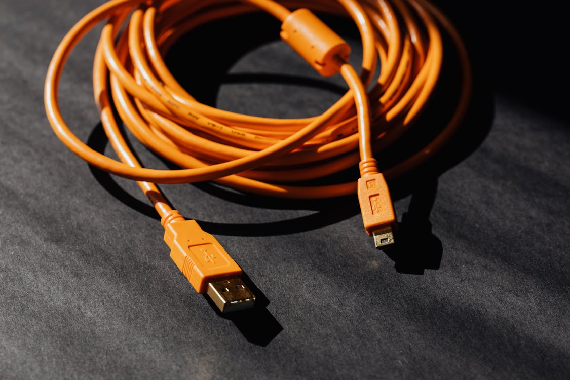 Tangle of USB and charging cables — the integration mess that MCP aims to solve for AI, the way USB-C solved it for hardware